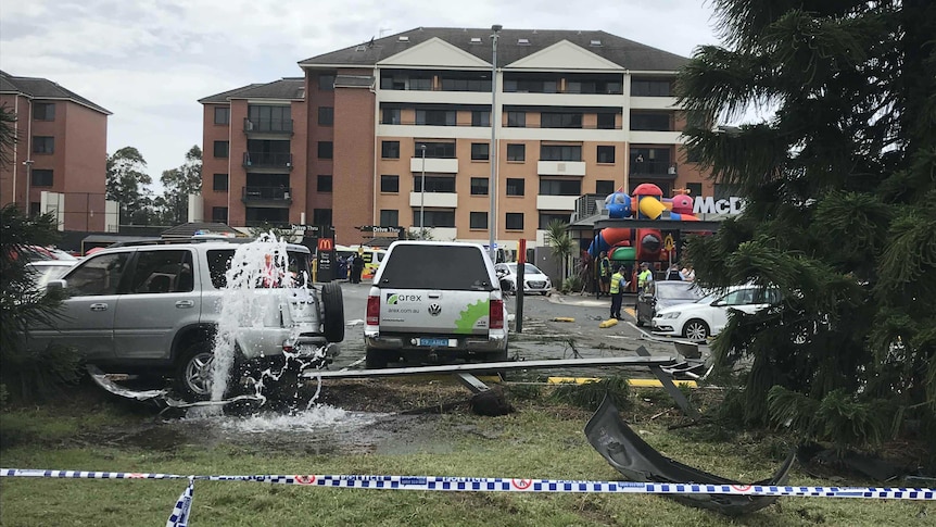 Damaged cars and a burst water main