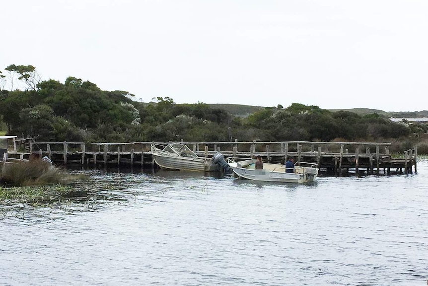 Couple in small boat at Arthur-Pieman Conservation Area.