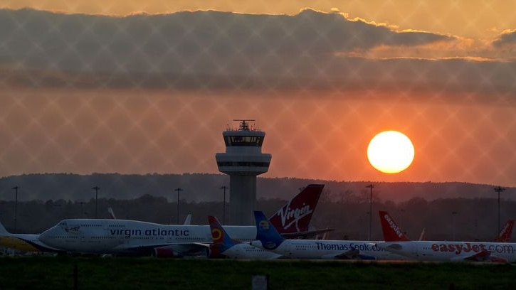 The sun sets over grounded aircraft at London's Gatwick Airport