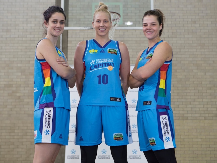 Canberra Capitals players show off their rainbow jerseys