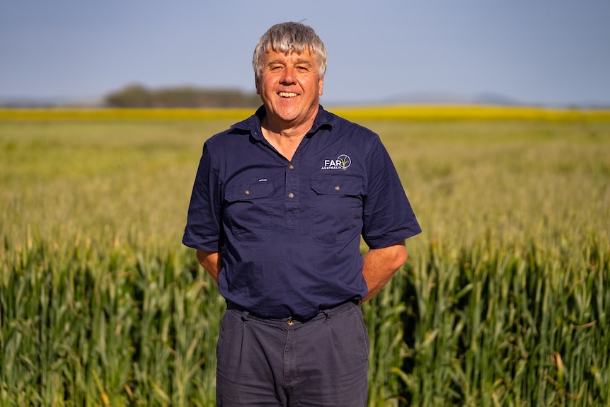 Photo of a man in a crop field 