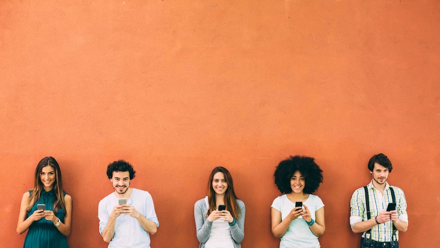 A group of people using smartphones