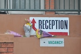 Close up of reception sign with flowers.