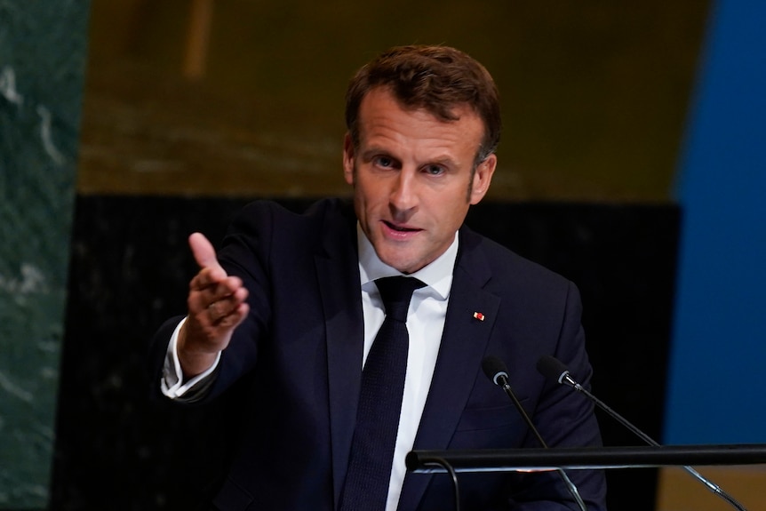 Emmanuel Macron gestures towards the audience as he speaks from the UN podium.