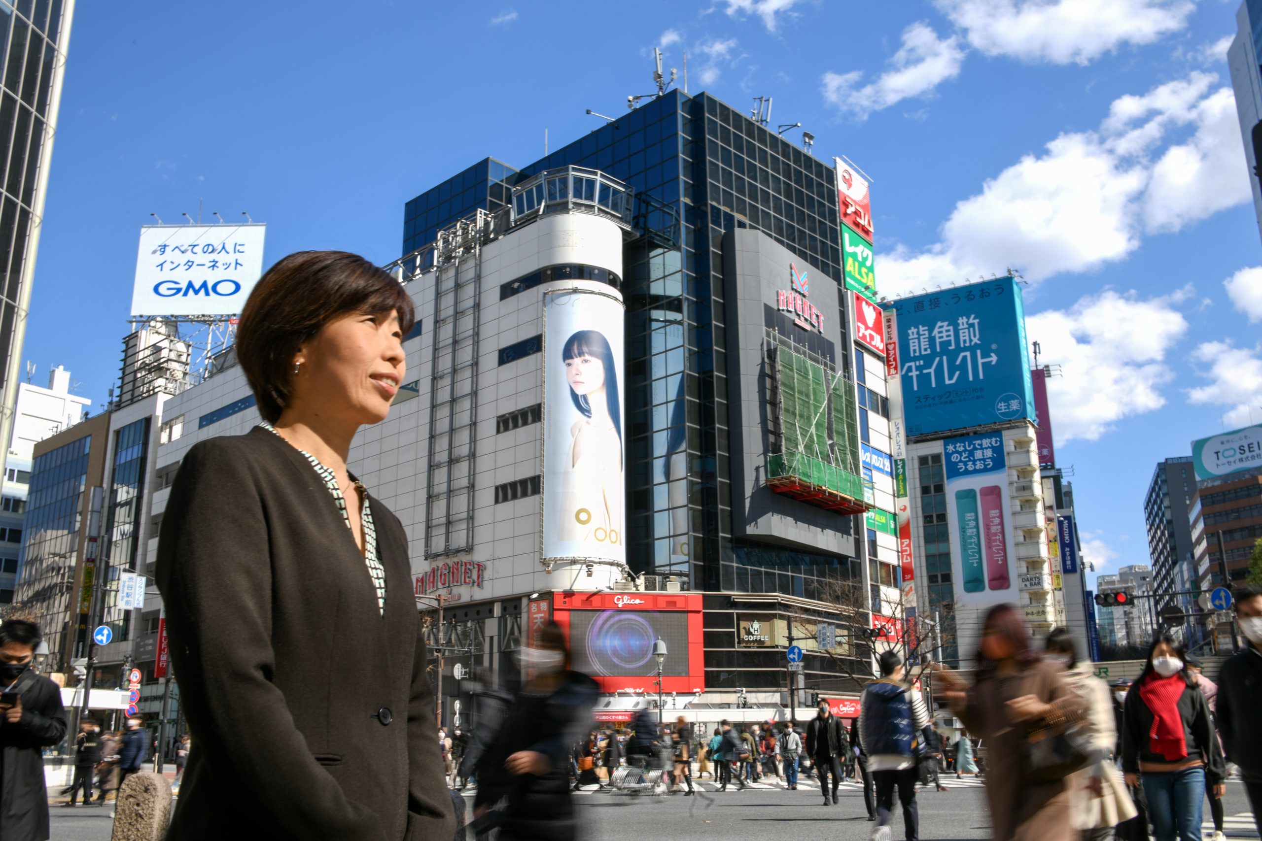 A woman standing on a city street. 