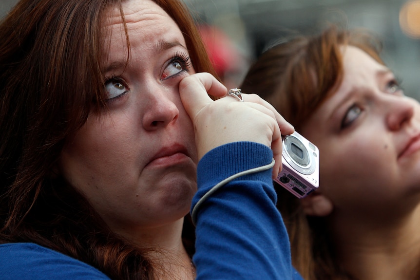 Woman cries during September 11 memorial