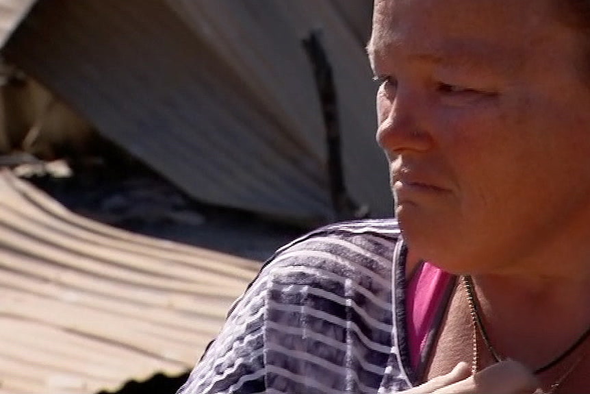 Chantal Fornasier looks sorrowfully at the wreckage of her house