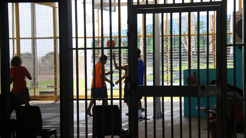 A group of kids play basketball in a youth detention facility in the NT.