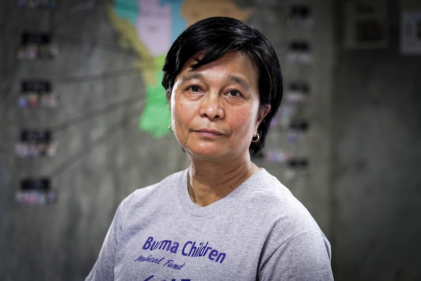 A Thai woman with close cropped hair in a grey t-shirt