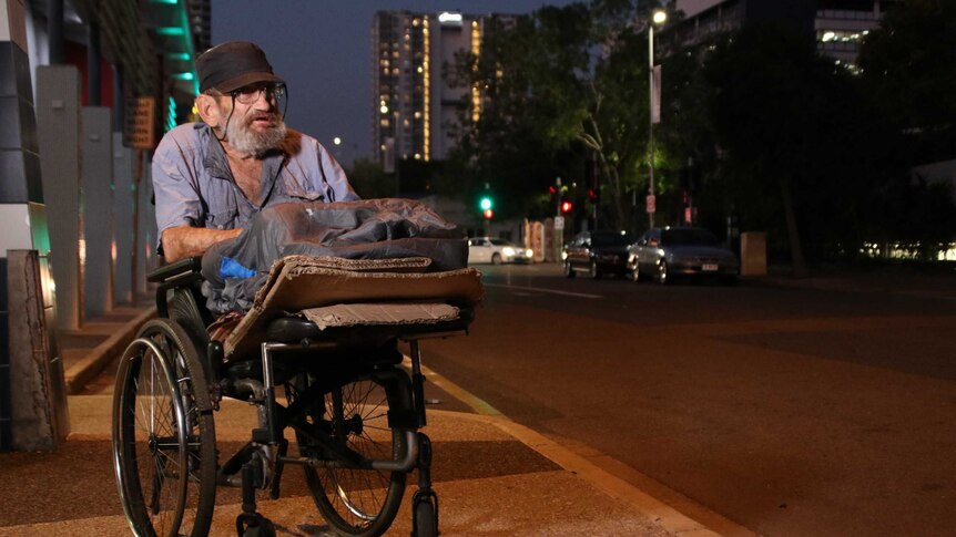 An 80 yea- old defence force veteran sits in his wheelchair on the streets of Darwin
