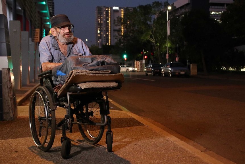 An 80 yea- old defence force veteran sits in his wheelchair on the streets of Darwin