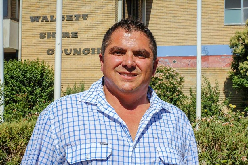 A man standing in front of the Walgett Shire Council building.