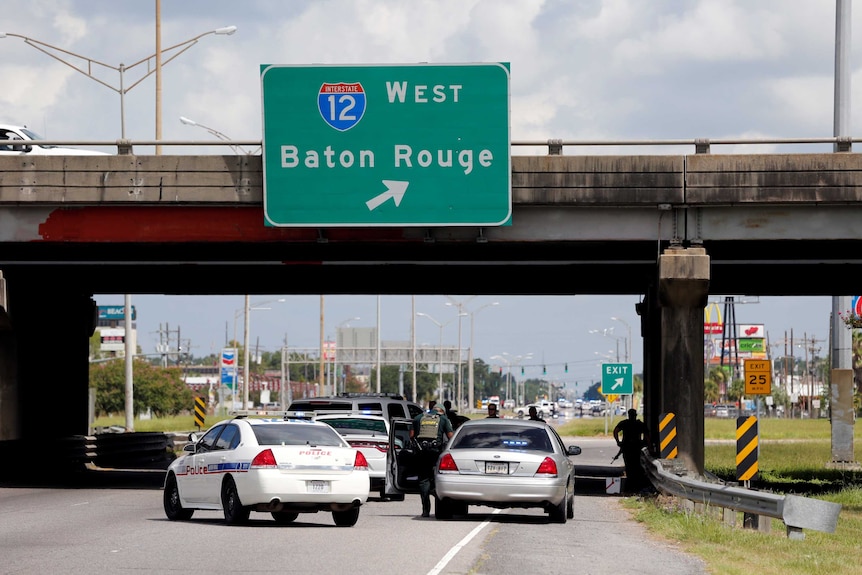 Police officers block off a road after a shooting of police in Baton Rouge.