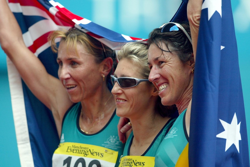 Three athletes draped in the Australian flag