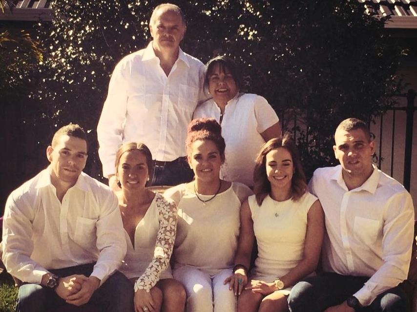 Erika Chapman-Burgess (seated second from left) with her parents and quintuplet siblings.