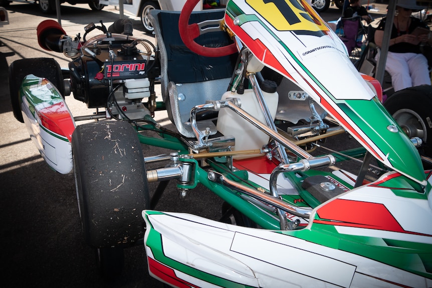 Custom built go kart with chrome pedal extensions and green and red racing decal