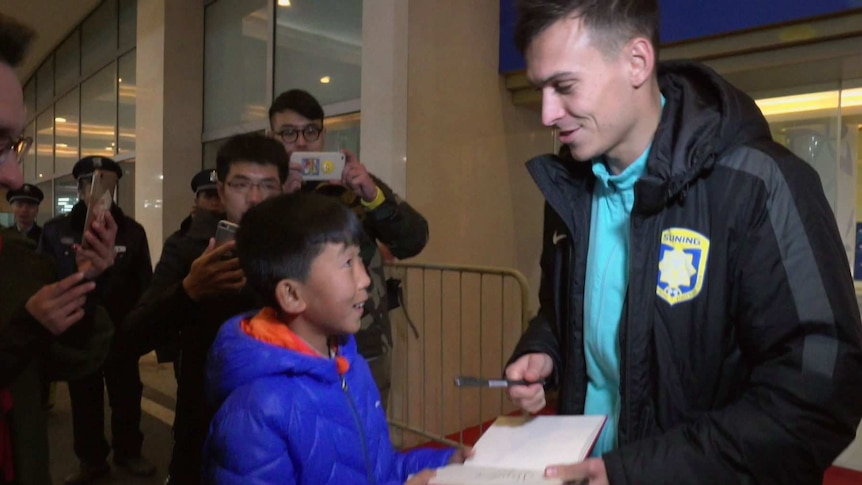 Young Chinese football player Gao Baosen, 12, meets Socceroo Trent Sainsbury, who plays for Jiangsu Suning FC.