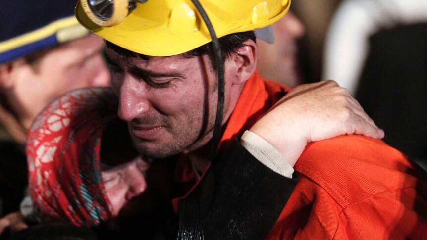 A rescued miner hugs a relative in Soma, Turkey after an explosion and a fire in a coal mine
