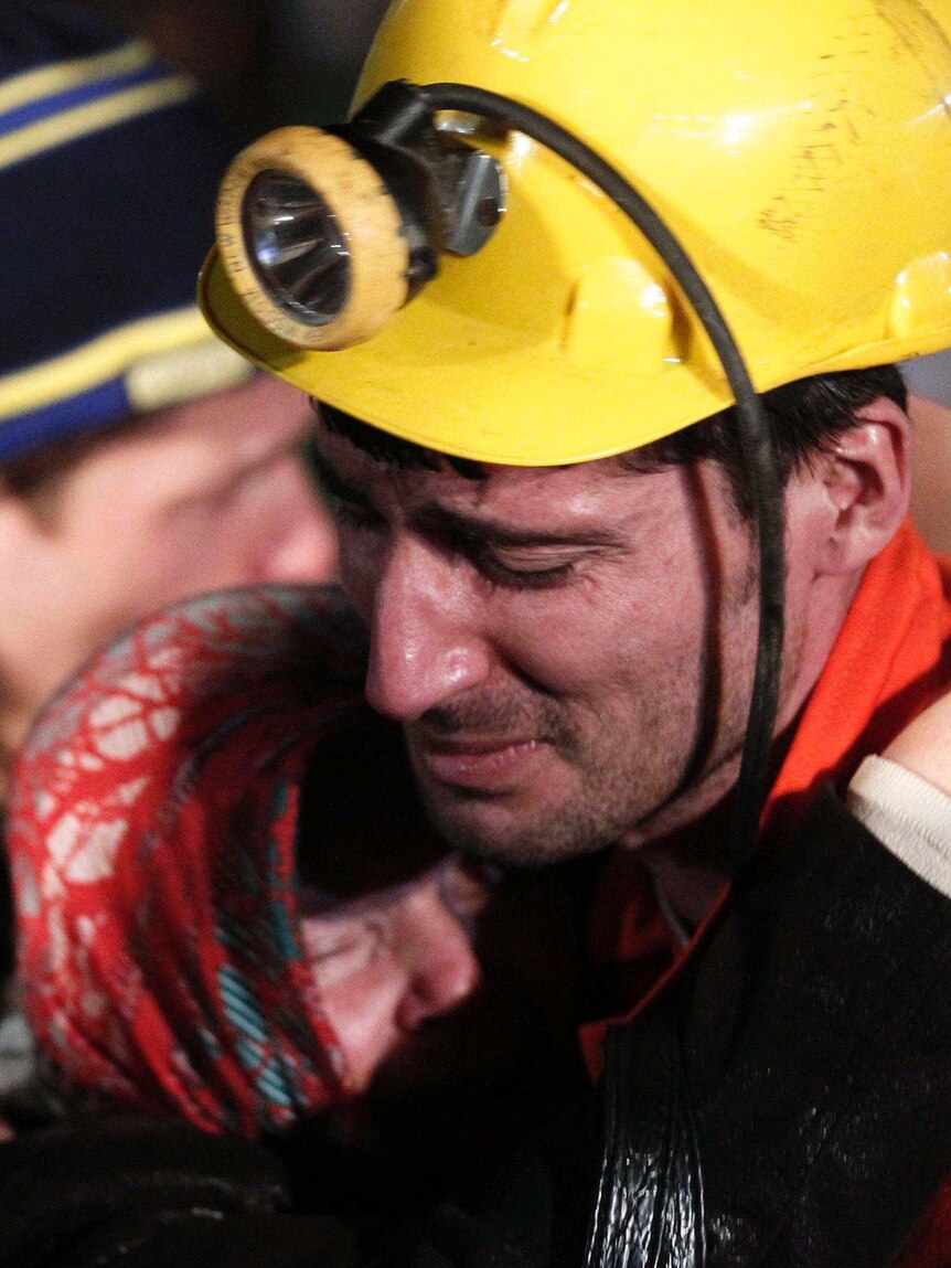 A rescued miner hugs a relative in Soma, Turkey after an explosion and a fire in a coal mine