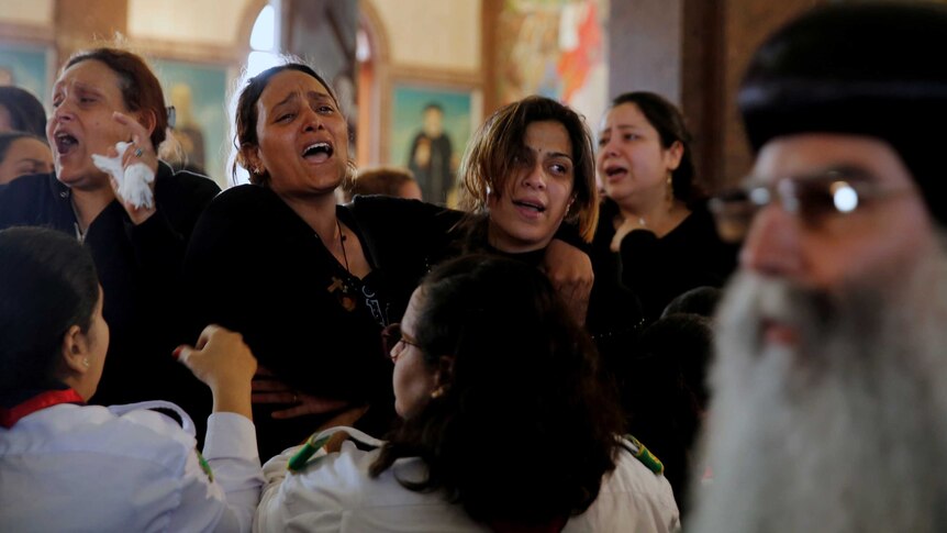 Relatives react as they mourn for the victims of the Palm Sunday bombings.