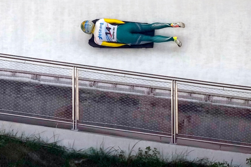 An overhead view of a woman competing in a skeleton race.