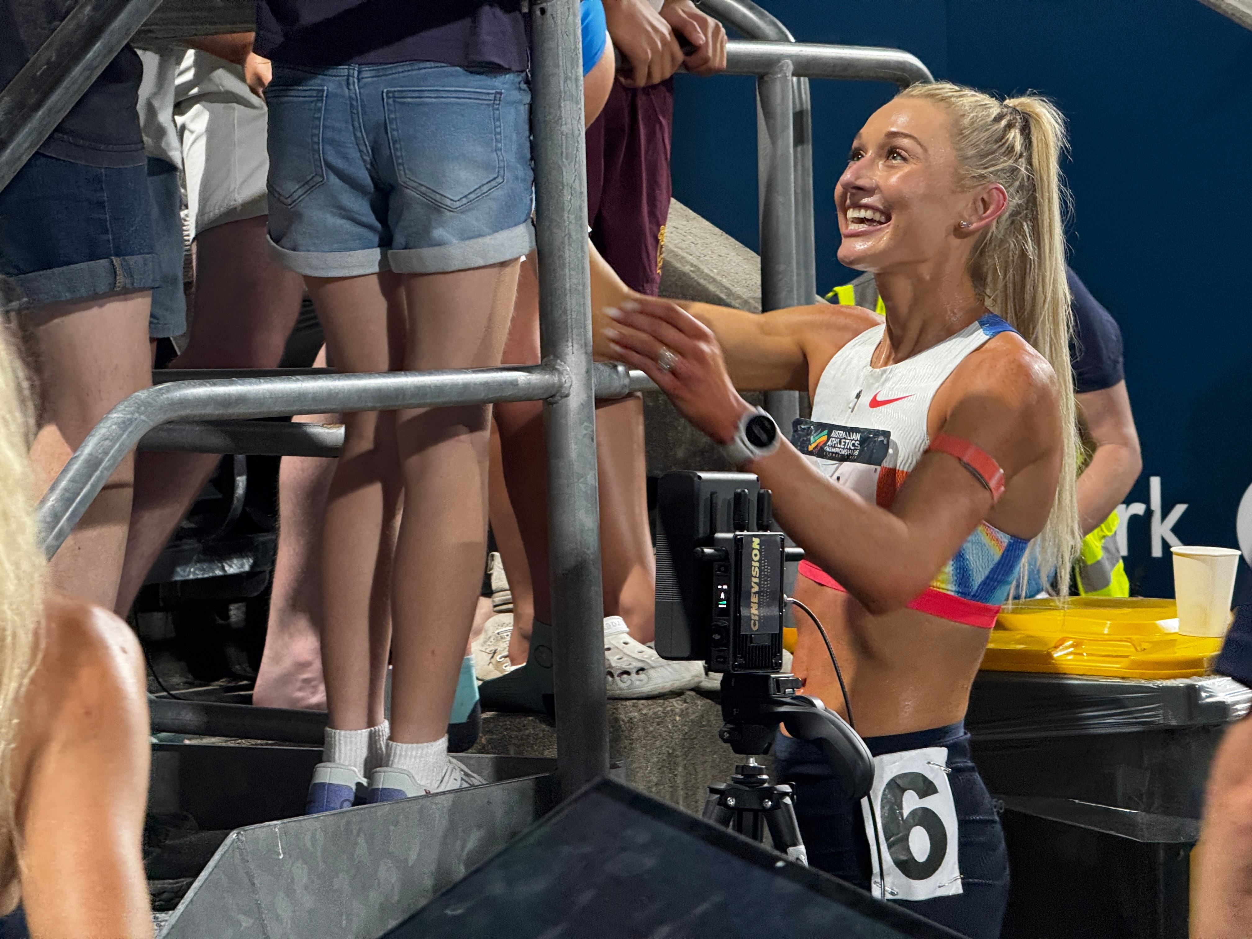 Runner Jess Hull smiles as she talks to fans