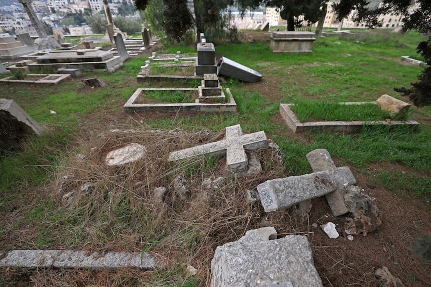 Toppled crosses from vandalised graves at Mount Zion cemetery