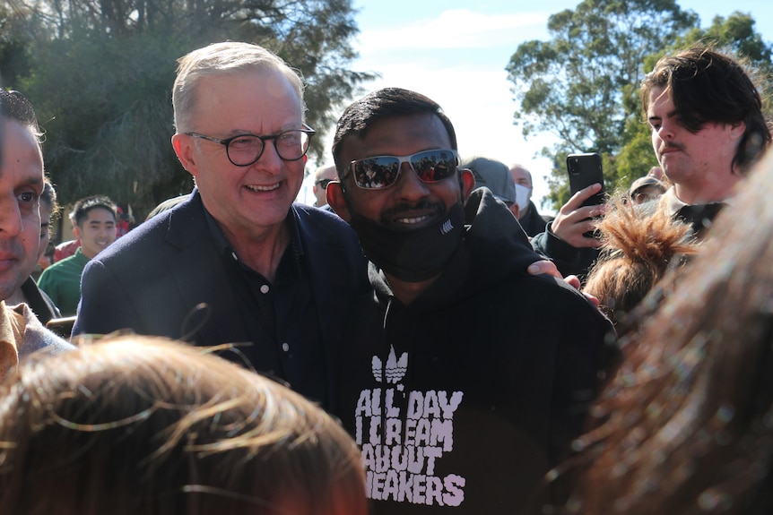 Anthony Albanese con miembros de la audiencia en una barbacoa comunitaria en Perth.