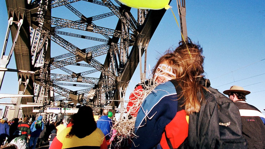 crowds of people walk over the Sydney Harbour Bridge in the walk for reconciliation in 2000