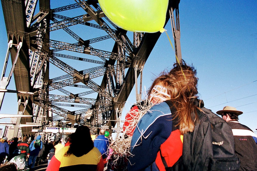 crowds of people walk over the Sydney Harbour Bridge in the walk for reconciliation in 2000