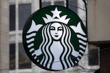 The Starbucks logo is seen on a shop's window.
