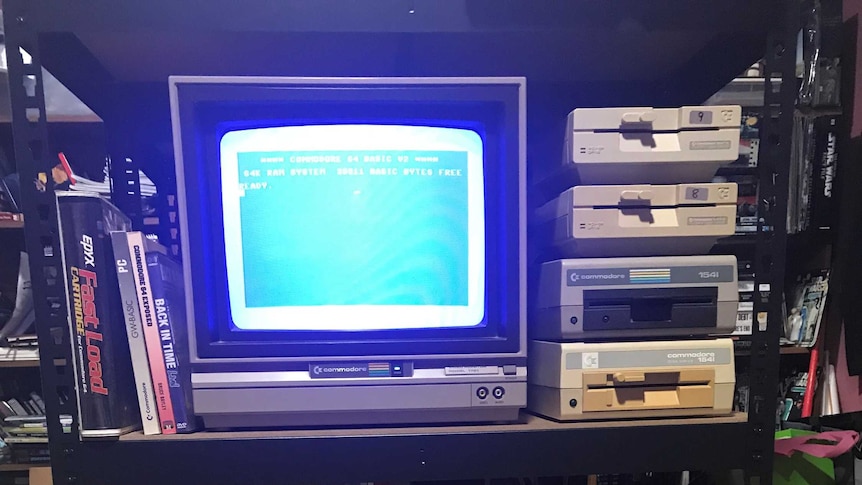 The old computer and keyboard sitting on a trolley.