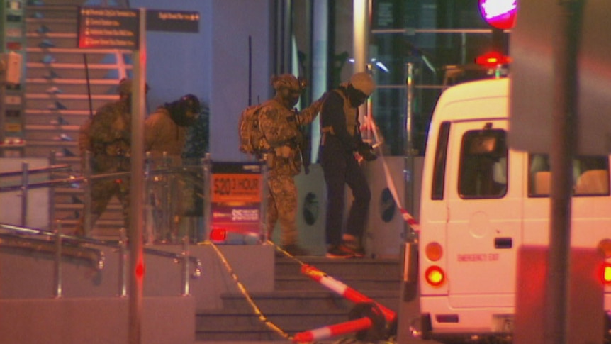 Commandos armed with semi automatic rifles and wearing body armour stage a G20 counter-terrorism training in Brisbane