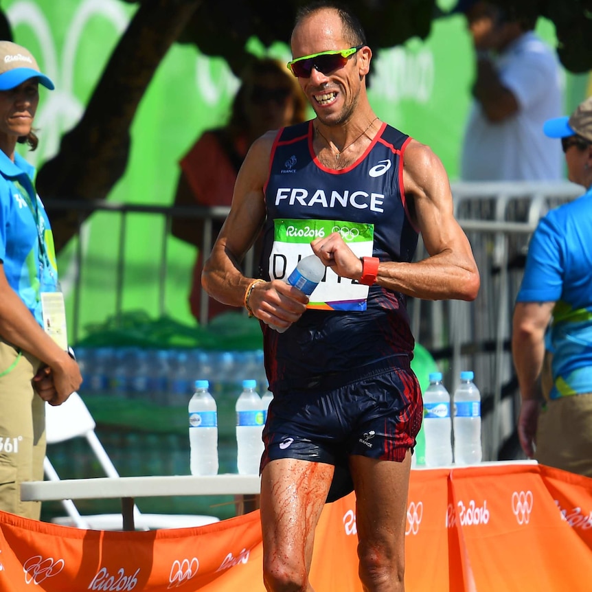 France's Yohann Diniz walking in the race with blood running down his leg