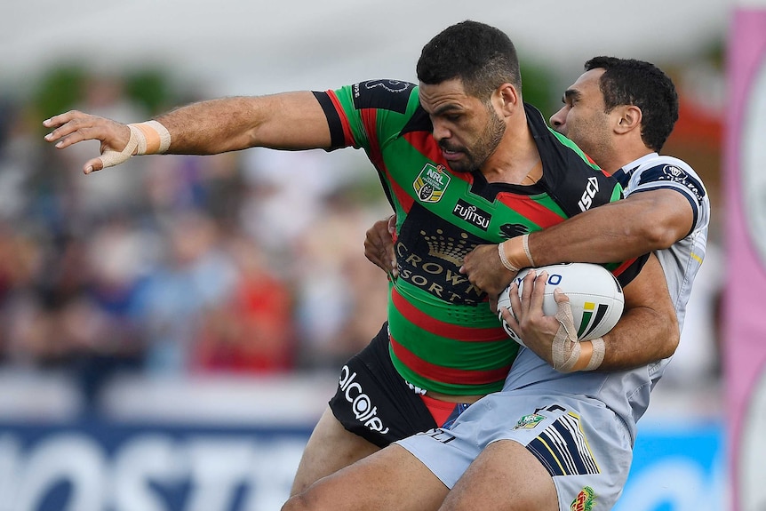 Greg Inglis is tackled by Justin O'Neill