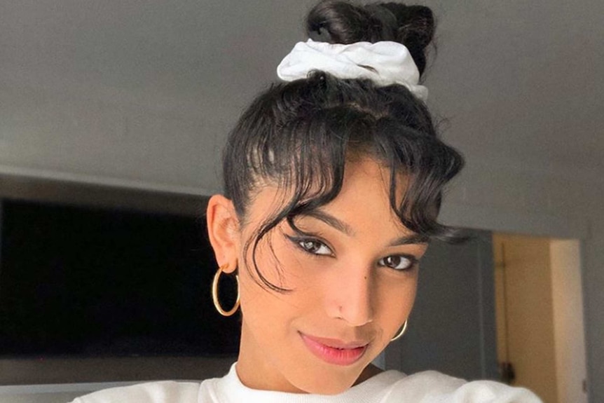 Sharon De Silva wearing a scrunchie and hoop earrings