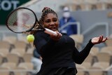 Serena Williams hits a forehand in front of empty stands at the French Open.
