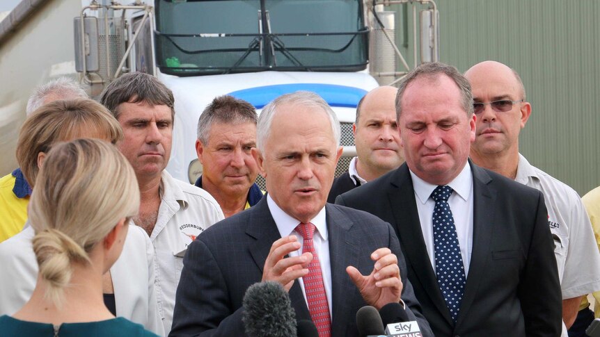 Malcolm Turnbull, standing in front of a truck, gestures as he speaks to truck drivers.