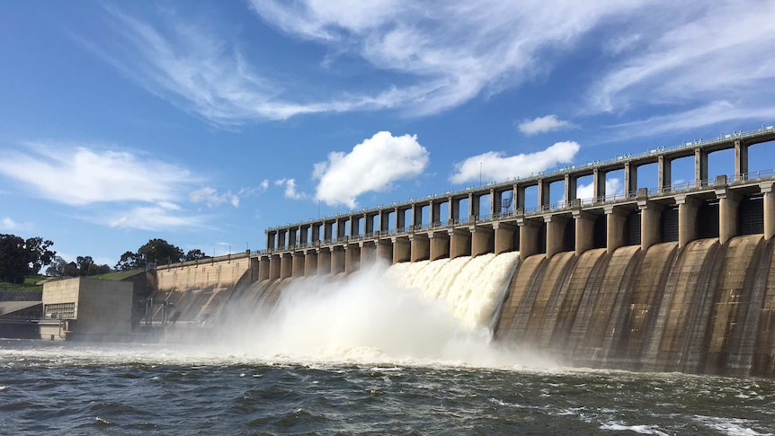 Water spills over a dam wall