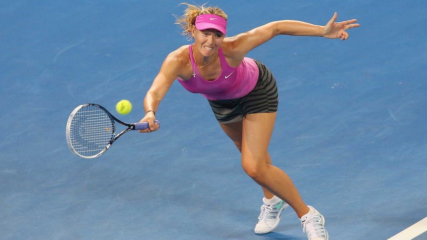 Maria Sharapova stretches for a return against Serena Williams at the Brisbane International