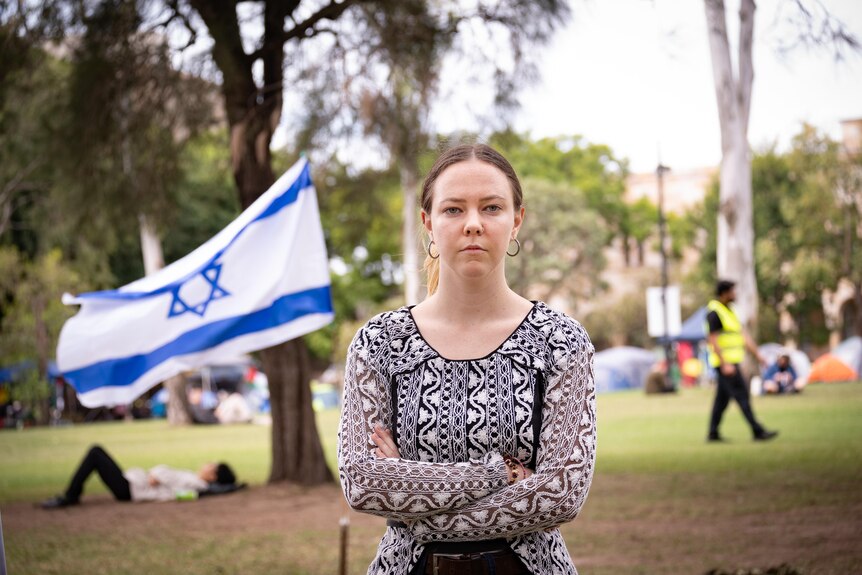 A woman next to an Israeli flag