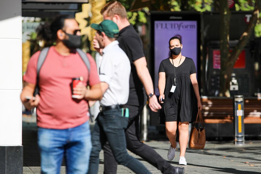 People walking in Perth's CBD wearing face masks.