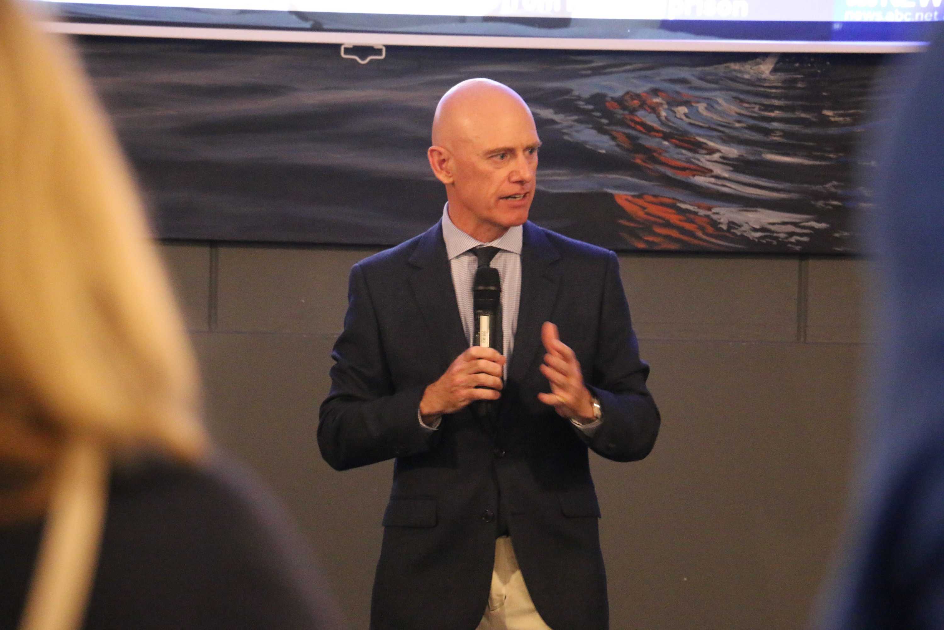 Liberal shadow treasurer Sean L'Estrange with a solemn expression addressing Liberal supporters