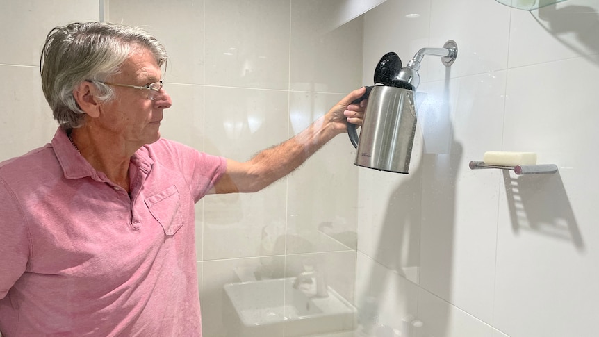 John Cornish must fill his kettle up in the shower in hotel quarantine. 