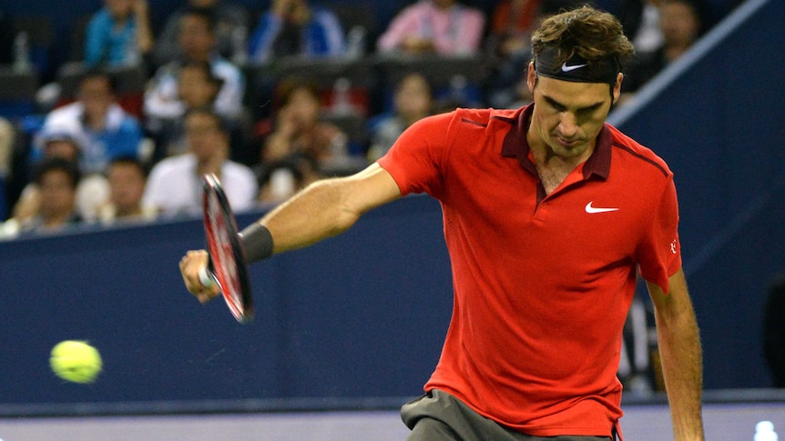 Roger Federer hits a backhand during the Shanghai Masters semi-final against Novak Djokovic