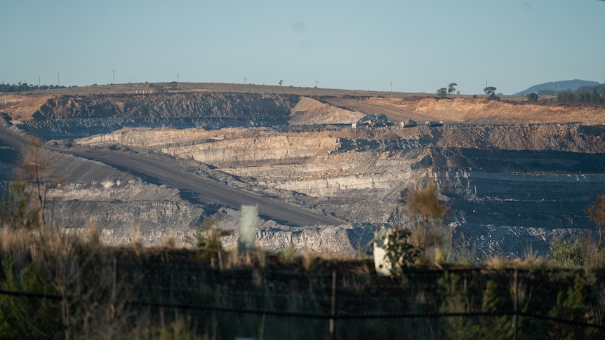 A hill with a coal mine cut out of the side