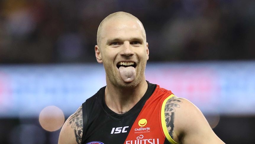 Jake Stringer from Essendon pokes out his tongue