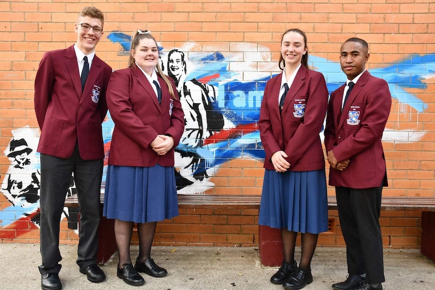 High school students Samuel Hudson, Bella Separovich, Clarice Boulten and William Simulata stand together.