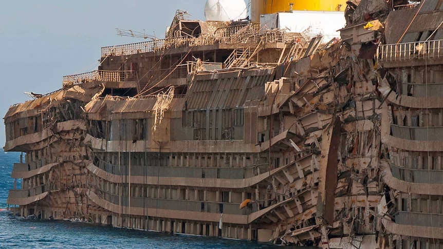 Exterior of one side of the ship, barely recognisable with crushed cabins and balconies.