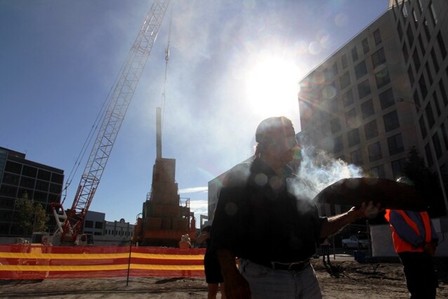 Aboriginal elder Uncle Bill Smith conducts a smoking ceremony on the site of Newcastle's new court complex.